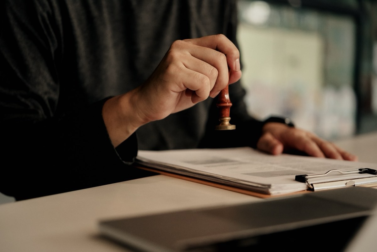 A document being signed off and stamped