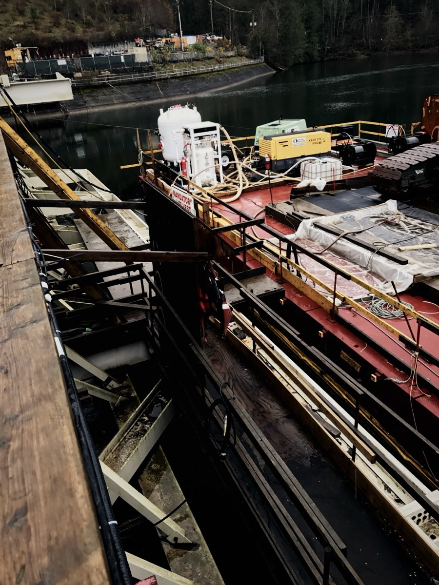 Work barge with equipment moored on calm water