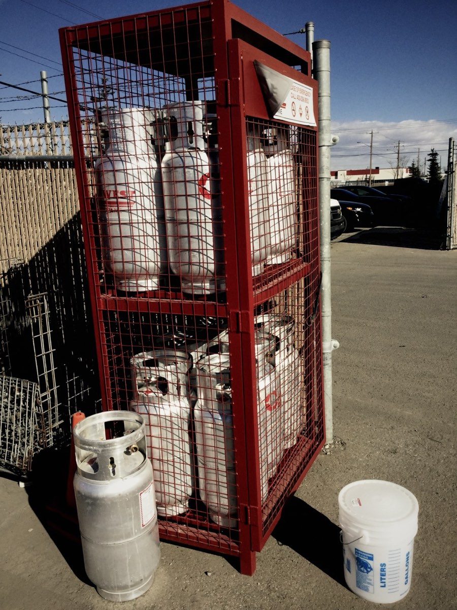 Gas cylinders stored in a locked outdoor cage