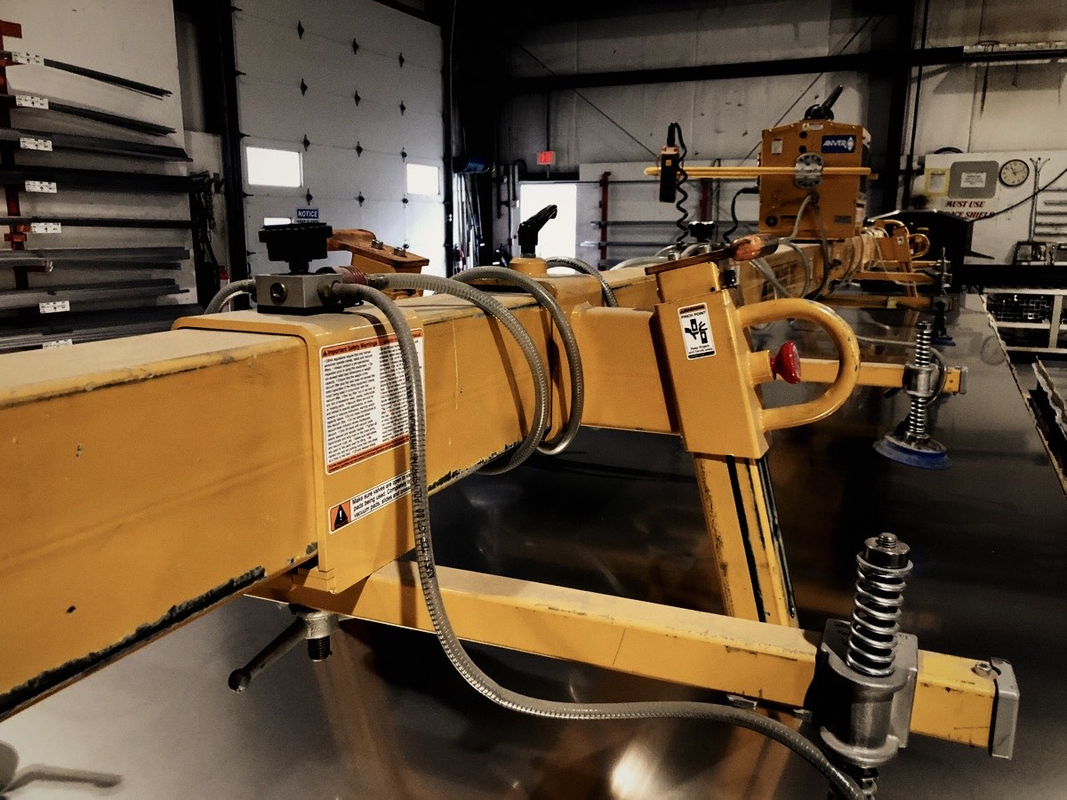 Yellow lifting device on a shop floor