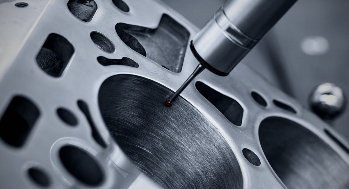 A coordinate measuring machine probe checking a precision metal part