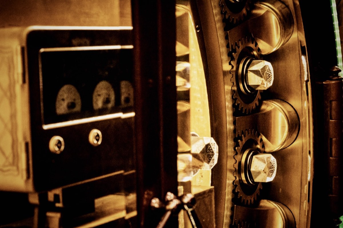 Brass gears and locking bolts of a heavy vault door